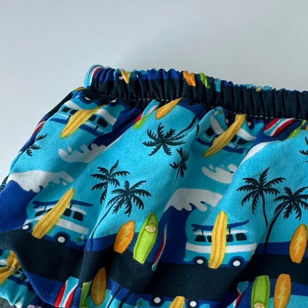 i play. Blue Surfboard and Palm Tree Swim Diaper